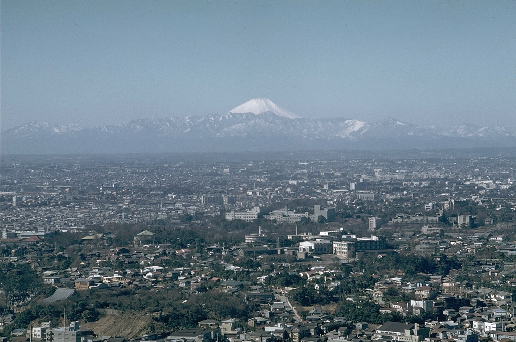 Mount Fuji rises above mountains at the SW end of the Kanto plain in this view from Tokyo Tower. Significant ashfall impacted the ancient capital of Edo (Tokyo), 100 km to the NE, during the last eruption in 1707. Photo by Richard Fiske, 1961 (Smithsonian Institution).