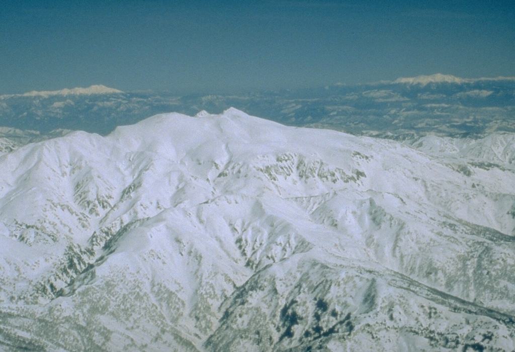 Hakusan is seen here from the W with the snow-covered peaks of Norikura and Ontakesan on the left and right horizons, respectively. It was constructed on a high basement of sedimentary rocks in a region of very heavy snowfall that has contributed to erosion. Eruptions were recorded over almost a thousand-year period until the 17th century. Photo by Ishikawa Prefecture (courtesy Toshio Higashino, Haku-san Nature Conservation Center).