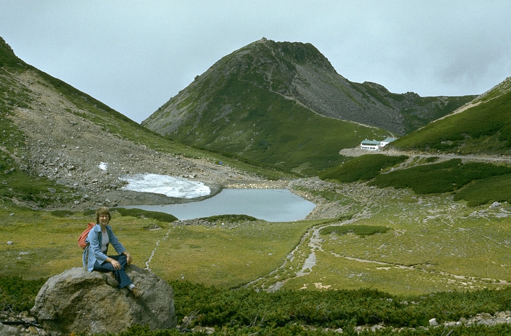 The summit of Norikura contains many small peaks and craters. The E (right) side of Enkodake (center) contains Kamegaike crater. Tsurugaike crater contains the pond in the center of the photo. The latest activity occurred during the Holocene and a recent eruption took place at the summit crater of Ichinoike. Photo by Lee Siebert, 1977 (Smithsonian Institution).