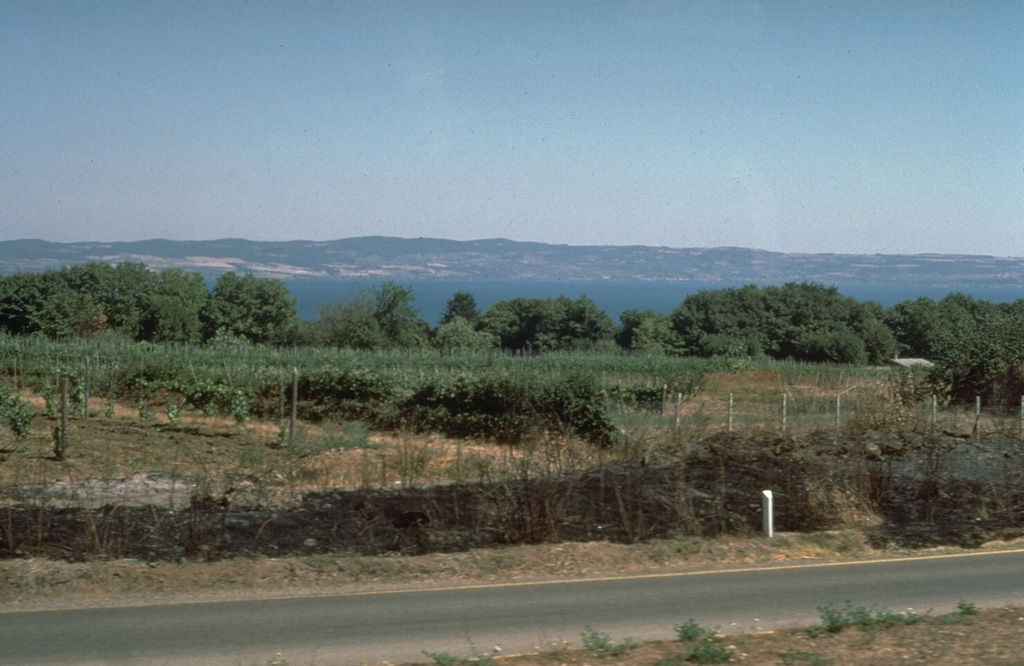 The 16-km-wide Bolsena caldera containing Lago di Bolsena, is the most prominent feature of the Vulsini volcanic complex NW of Rome. The 2,000 km2 volcanic complex also includes the Latera caldera to the west. Both calderas were formed during the Pleistocene. Post-caldera eruptions produced scoria cones, lava flows, and youthful-looking cones that form islands in Lago di Bolsena. Photo by Richard Waitt, 1985 (U.S. Geological Survey).