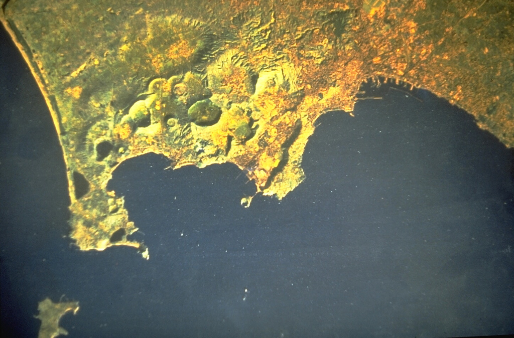 A Landsat satellite image shows the Campi Flegrei caldera north of the Bay of Naples. The 13-km-wide caldera, immediately west of the city of Naples (upper right), was created following massive explosive eruptions about 34,000 and 12,000 years ago. Subsequent eruptions formed numerous craters and cones within the caldera and along its margins. The most recent eruption created the Monte Nuovo tuff cone in 1538. NASA Landsat image, 1984.