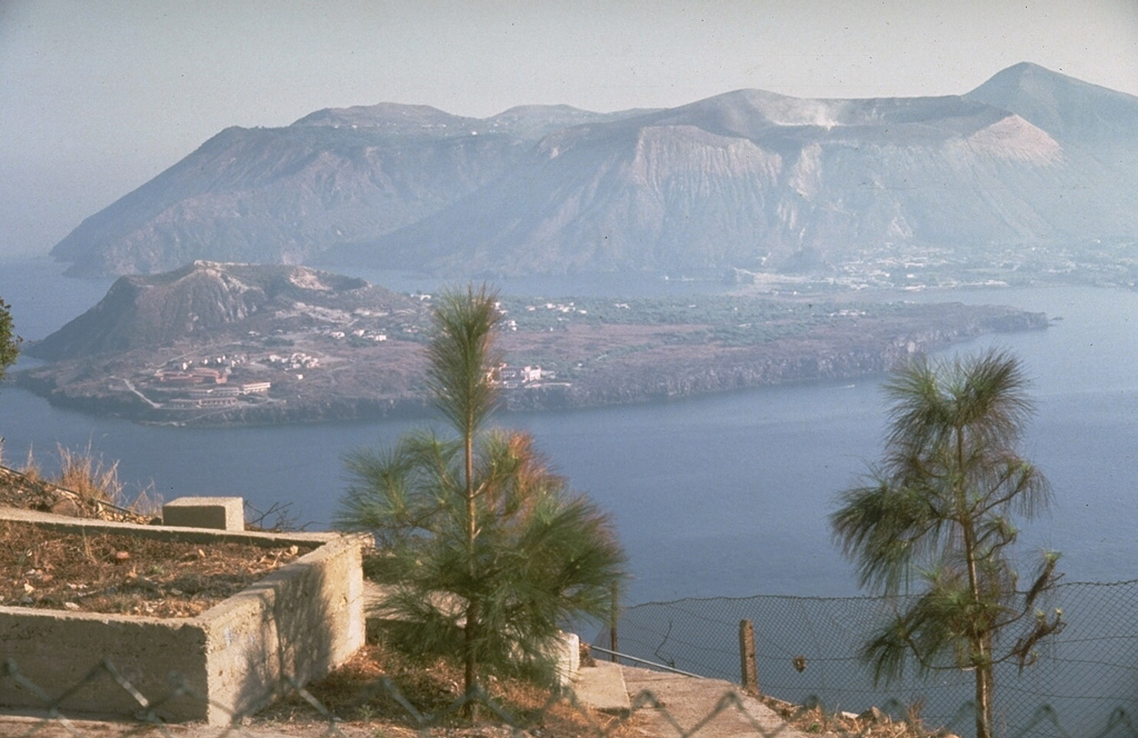 The island of Vulcano in Italy's Aeolian Islands is seen here from the volcano observatory on the island of Lipari to the north, with the volcanic peninsula of Vulcanello, initially formed in 183 BCE, in the foreground and Fossa cone in the background. Vulcano consists of at least three volcanic complexes, each of which is truncated by a small caldera. Volcanism has migrated to the north with Fossa cone being the dominant Holocene center. The latest eruption took place from 1888 to 1890. Photo by Richard Waitt, 1985 (U.S. Geological Survey).
