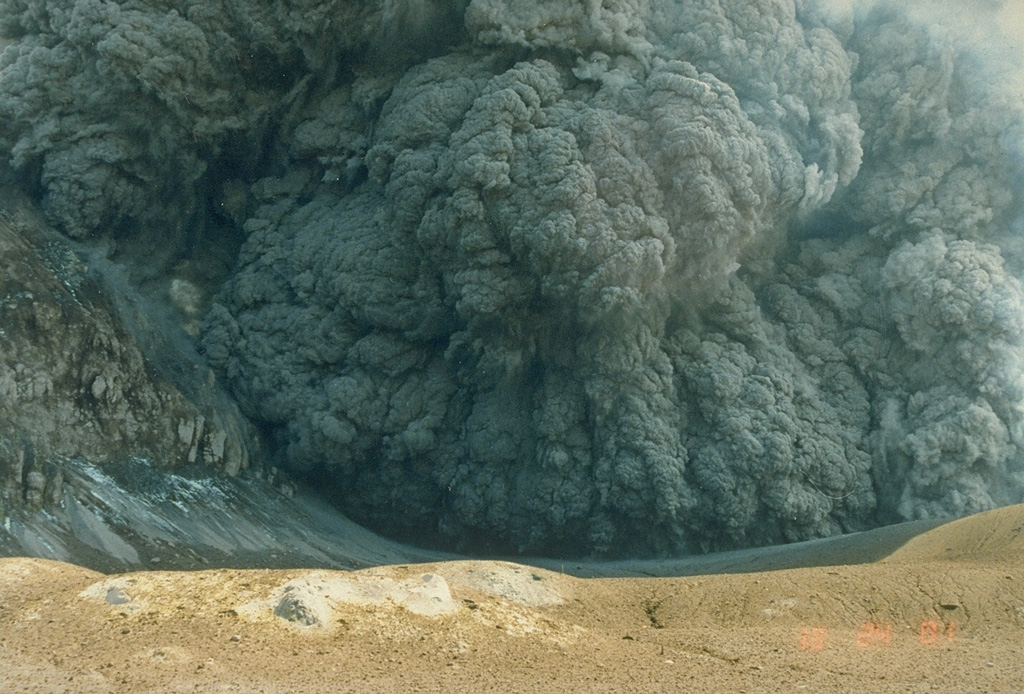 An ash plume erupting from the crater of White Island (also called Whakaari) on 25 March 1988. This was one of many phreatomagmatic and magmatic eruptions that took place from 1986 to 1994 from the small island volcano 50 km NE of New Zealand's North Island. Large eruptions on 14 March and 27 April 1988, produced 3.5-km-high ash plumes. Photo by Ian Nairn, 1988 (New Zealand Geological Survey).