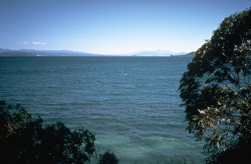Lake Taupo fills a roughly 35-km-wide caldera that is the site of the most prolific rhyolitic volcano of the Taupo volcanic zone. The caldera was formed during two major explosive eruptions, the Oruanui eruption, roughly 22,600 years ago, and the Taupo eruption, about 1,800 years ago. The latter was one of the world's largest Holocene eruptions. Additional Plinian eruptions during the Holocene have produced widespread airfall pumice deposits. Photo by Richard Waitt, 1986 (U.S. Geological Survey).