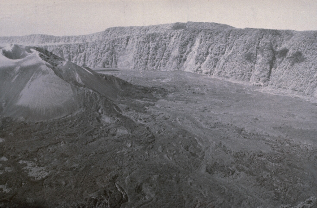 A dominantly effusive eruption with Strombolian activity took place from the Bagiai cone (upper left) in the central caldera during February to August 1974. Lava flows were produced throughout the eruption, except for a 25-day period in July, and covered much of the inner caldera floor. This view from the S caldera rim on 13 September 1974 shows lava flows that were erupted during a period of increased lava effusion on 22 July to 8 August, from a new vent on the SE side of Bagiai. Photo courtesy of William Melson, 1974 (Smithsonian Institution).