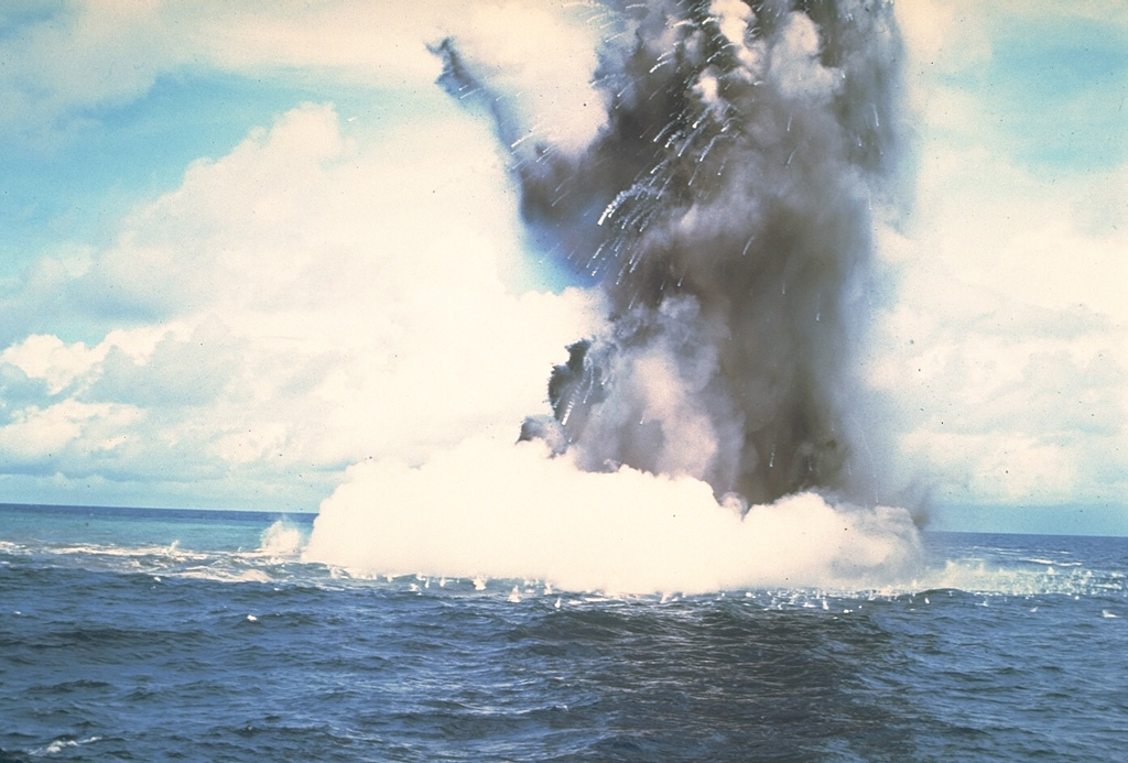 A Surtseyan cock’s-tail plume rises above the sea surface at Kavachi volcano on 17 or 18 July 1977. Additional explosions were seen 19-22 July, with vapor and ash clouds reaching several hundred feet above the sea surface. This activity is typical of submarine eruptions from Kavachi, one of the most active volcanoes of the Solomon Islands. At least eight new ephemeral islands have been formed since an eruption in 1939. Photo by W.G. Muller, 1978 (Barrier Reef Cruises, Queensland, Australia; courtesy of D. Tuni).
