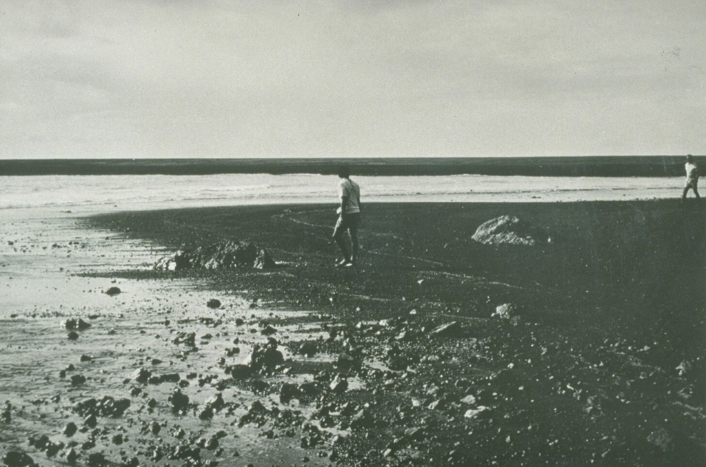 Ten days after a new island formed during a one-day submarine eruption in 1971, scientists investigate the surface of the new land. Ash plumes had been ejected to a height of 1 km. A low island 70 x 200 m had formed, with its block-littered surface one meter above high tide level. The Karua submarine volcano was constructed within the 6 x 12 km Kuwae caldera. Photo courtesy Geological Survey, New Hebrides, 1971.