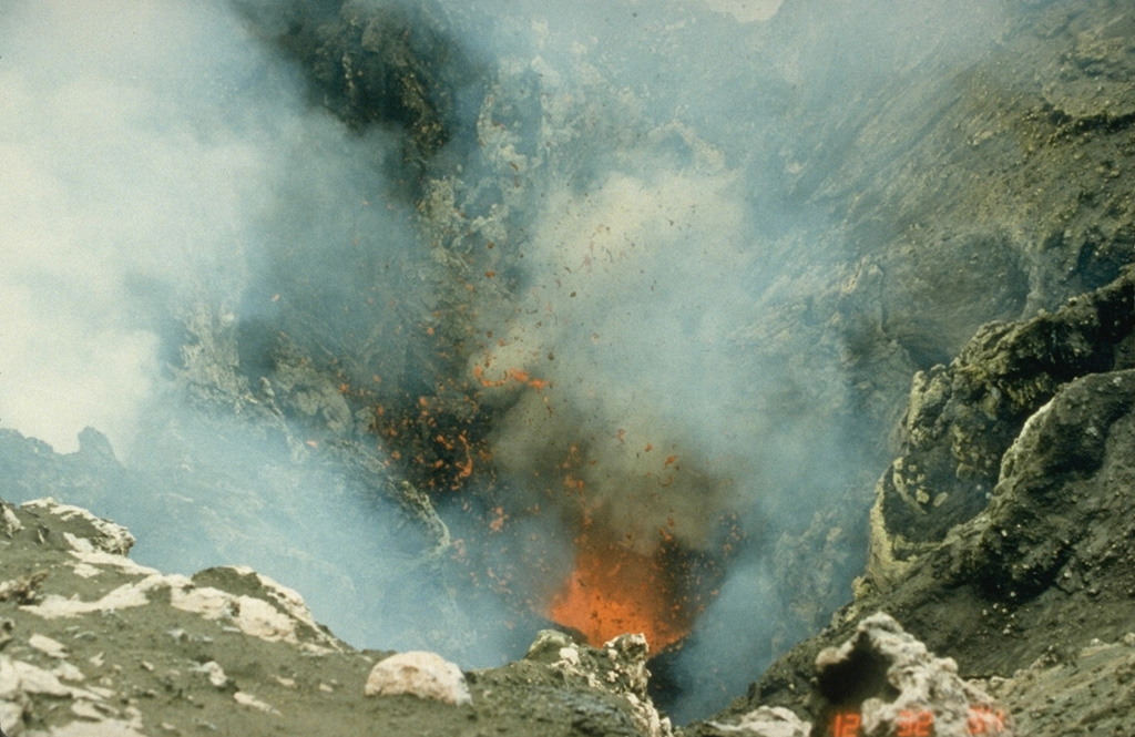 Incandescent spatter is ejected from a vent in the summit crater of Yasur volcano on 8 September 1988. The volcano has produced continuous Strombolian or Vulcanian activity since at least 1774. The mild activity seen here is occasionally interrupted by more violent explosive activity, such as during 1878, 1968, 1972, 1974-75, and 1977. Photo by Ian Nairn, 1988 (New Zealand Geological Survey).
