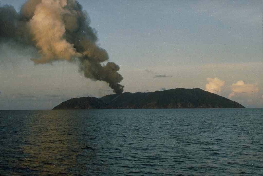 An ash plume in 1991 rises above Barren Island along the volcanic arc connecting north of Sumatra. The 3-km-wide island contains a 1.6-km-wide crater that is partially filled by a scoria cone that has been the source of eruptions since the first was recorded in 1787. Lava flows reached the coast during several recent eruptions. Photo courtesy of D. Haldar, 1991 (Geological Survey of India).