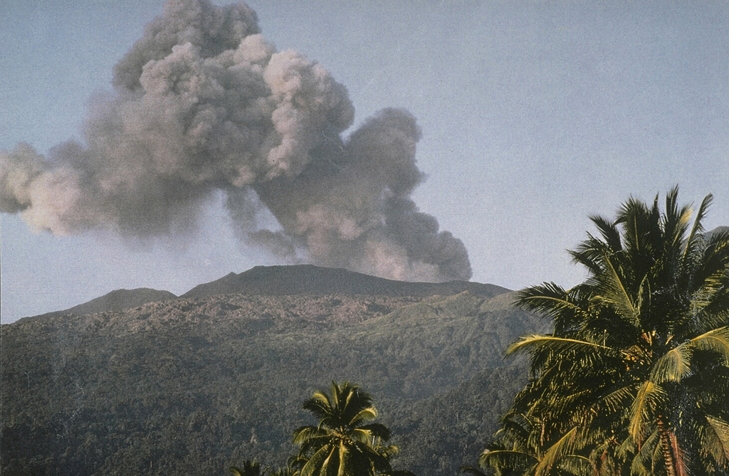 An ash plume rises from the summit of Dukono volcano in June 1991.  The isolated volcano of Dukono at the northern end of Halmahera Island is one of Indonesia's most active, displaying more or less continuous explosive activity since 1933, when a new cinder cone was formed in Malupang Magiwe crater. Photo by Vivianne Clavel, 1991.