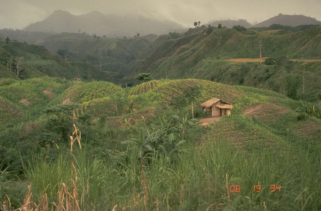 Parker volcano, seen here from the E, is located at the S end of Mindanao Island in the Philippines. Reconnaissance studies of the volcano revealed resemblances to Pinatubo volcano, which also produced thick of pyroclastic flow deposits around its flanks. Parker is now thought to be the source of a major eruption in 1641 that plunged much of Mindanao into darkness.  Photo by Chris Newhall (U.S. Geological Survey).