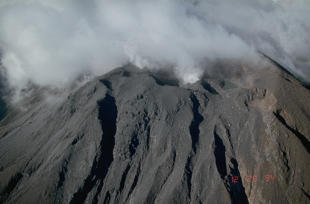 Frequent eruptions have been recorded since the mid-19th century and have kept the summit of Bulusan volcano unvegetated. The principal summit crater is 300 m wide and 50 m deep, with two craters are located on the lower SE flank, the lower of which contains a crater lake. Photo by Chris Newhall (U.S. Geological Survey).