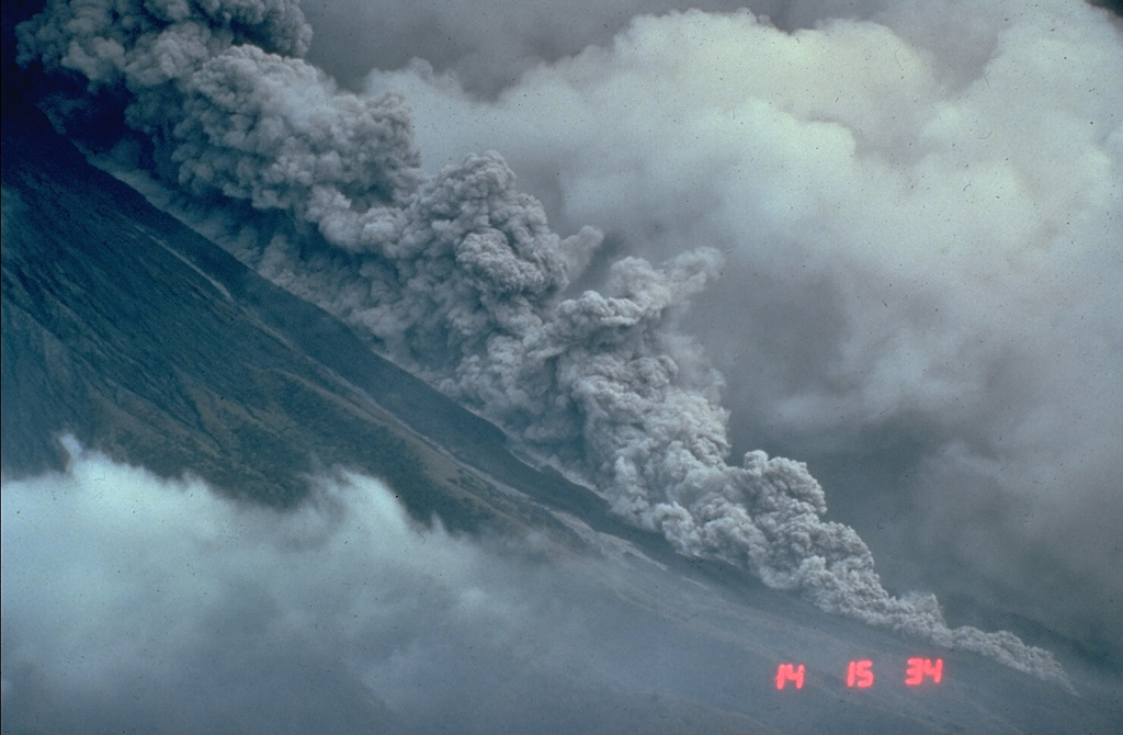 Pyroclastic flows are hot avalanches of rock, ash, and gas that sweep down the flanks of volcanoes at high velocities. This photo shows a relatively small pyroclastic flow at Mayon volcano in the Philippines on 23 September 1984. These hot, ground-hugging flows can travel at velocities to about 100 km/hour and reach areas well beyond the flanks of a volcano. Their high temperatures make them lethal to anything in their path. Hot ash plumes rise above the denser basal portion that can contain abundant solid blocks and ash. Photo by Chris Newhall, 1984 (U.S. Geological Survey).