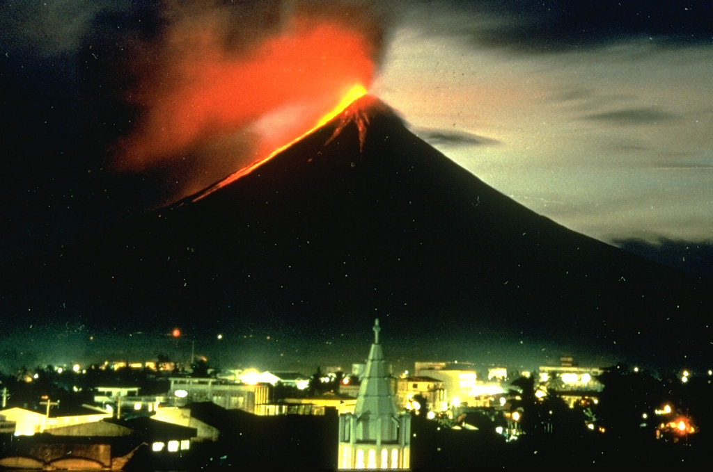 A nighttime view from Legaspi City on 14 September 1984 shows incandescent lava flows descending the SW flank of Mayon volcano in the Philippines. The flows traveled about 4 km to the lower flanks of the volcano, adjacent to previous flows from eruptions in 1968 and 1978. Photo by Norm Banks, 1984 (U.S. Geological Survey).