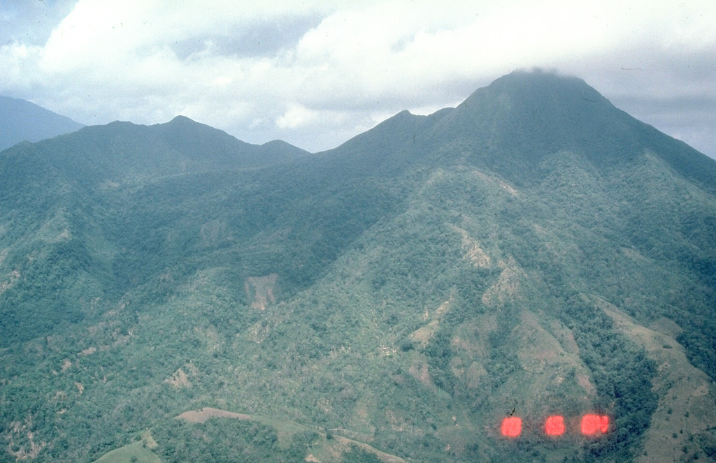 Vegetated Masaraga, seen here from the south, is located NW of Mayon volcano. An eroded volcanic ridge extends to the NW and thick lava flows have been emplaced on the flanks Photo by Chris Newhall (U.S. Geological Survey).