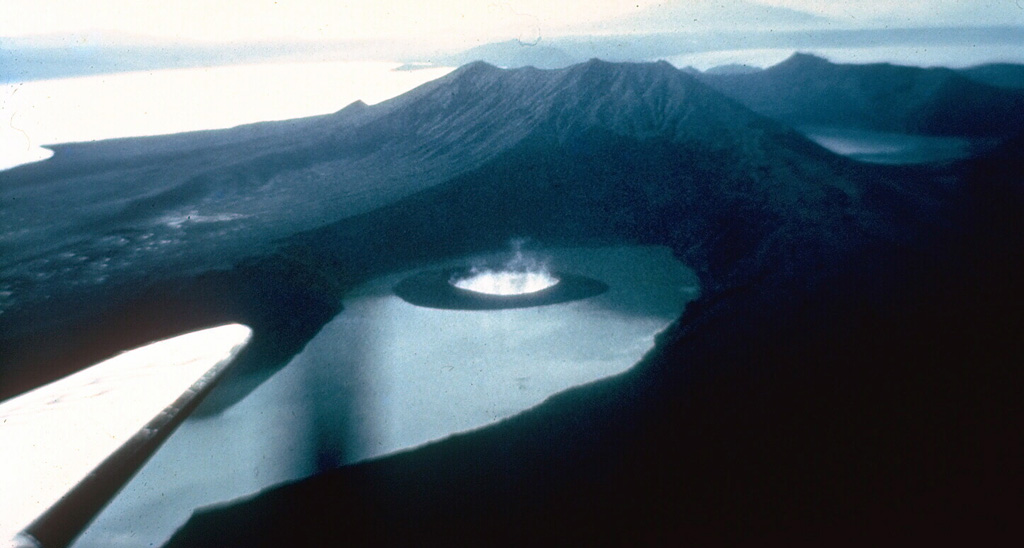 The small tuff cone in the center of this photo was produced towards the end of a powerful 1965 explosive eruption of Taal in the Philippines. The eruption from 28 to 30 September originated from a fissure on the SE flank of Volcano Island and produced devastating pyroclastic surges when lake water gained access to the vent. The vent is filled by an inlet of Lake Taal in this 1965 post-eruption photo from the S. Eruptions the following year almost completely filled this new inlet. Photo by Jim Moore, 1965 (U.S. Geological Survey).