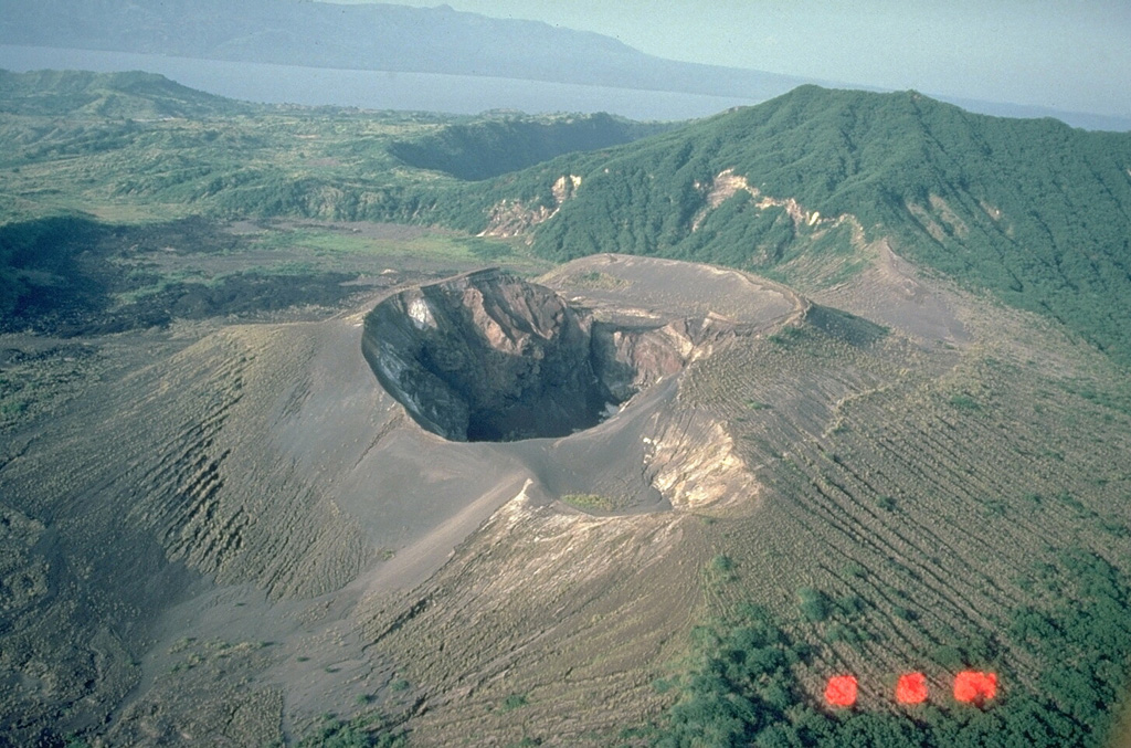 This 400-m-wide crater formed during an eruption of Taal in 1976. That eruption modified cones and craters that had been constructed during yearly eruptions from 1966 to 1970 within a larger crater that formed during the 1965 eruption. This 1984 photo from the SW also shows the small 1977 crater along the margin of the flat bench at the upper right side of the 1976 crater. Photo by Chris Newhall, 1989 (U.S. Geological Survey).