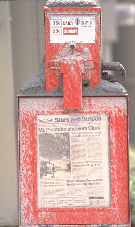 This ash-covered newsstand on Clark Air Base holds a newspaper with the headline “Mt. Pinatubo showers Clark.” Powerful eruptions of Pinatubo volcano in June 1991 forced closure of the base. Photo by Val Gempis, 1991 (U.S. Air Force).