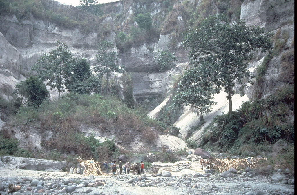 A thick stack of pre-1991 pyroclastic flow and lahar deposits outside Clark Air Base is testimony to the long history of explosive eruptions at Pinatubo. Six major eruptive periods took place in the past 35,000 years, each separated by long periods of quiescence. Most of the previous eruptive periods produced explosions that were even larger than the 1991 eruption. The last major eruption prior to 1991 occurred about 500 years ago. Photo by Chris Newhall (U.S. Geological Survey).