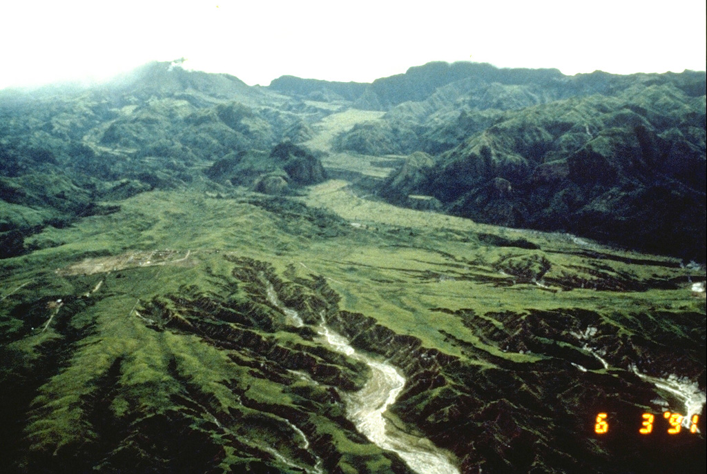 The flat, lighter-green, vegetated deposit that winds down the valley at the top center of the photo is a pyroclastic flow fan from the last major eruption of Pinatubo prior to 1991, about 500 years ago. This photo, taken on 3 June 1991, shows the pre-eruption profile of the upper Marella River valley.   Photo by Rick Hoblitt, 1991 (U.S. Geological Survey).