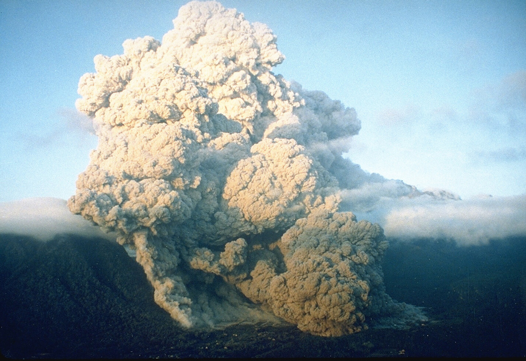 A pyroclastic flow on 23 June 1993 at Unzen volcano in southern Japan travels down the flanks of the volcano into the Senbongi residential district of Shimabara city. Pyroclastic flows had been occurring at Unzen since May 1991 as a result of partial collapse of the lava dome growing at the summit of Fugendake. This pyroclastic flow traveled 1 km through inhabited areas that had been evacuated since August 1991. One resident who had returned to watch his house burn was killed by a second pyroclastic flow. Photo by Setsuya Nakada, 1993 (Kyushu University).