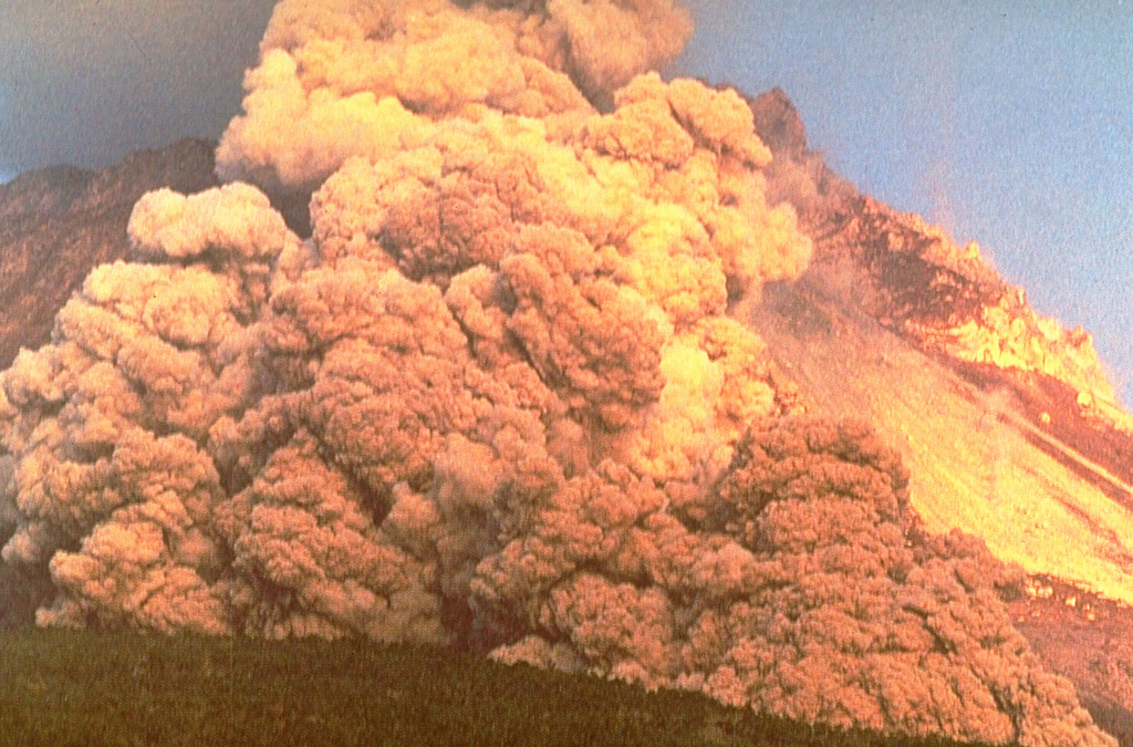 A block-and-ash flow travels down the flank of Fugendake in 1991. These were created by collapse of a lava dome that began on 24 May. The size of the flows gradually increased and on 3 June the largest flow of the eruption to that point swept 3 km down the Mizunashi River valley into Kita-Kamikoba village, killing 43 people and destroying many houses. On 8 June block-and-ash flows traveled 5.5 km to within 50 m of a major highway and destroyed an additional 73 houses. Photo courtesy Willie Scott, 1991 (U.S. Geological Survey).