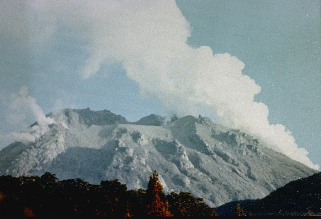 Gas-and-steam plumes rise from vents on the Niigata-Yakeyama lava dome on 3 August 1974, shortly after a brief explosive eruption on 28 July. The eruption killed three climbers and produced ashfall that damaged crops. Several craters formed during recorded eruptions that date back to the 9th century at the summit and flanks of the dome. Photo courtesy of Japan Meteorological Agency, 1974.