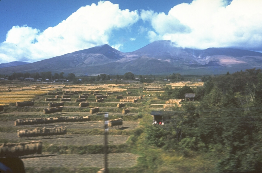 The N flank of Chokaisan was the source of a large debris avalanche about 2,600 years ago that traveled 25 km into the Japan Sea and underlies much of the foreground area. Collapse of the summit left a 3 x 4 km open scar with the eastern rim forming the left-center peak, and the western rim to the right. Following the collapse, a series of lava domes and lava flows filled the upper area and formed the center peak. Photo by Ichio Moriya (Kanazawa University).