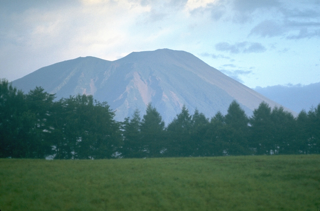 Yakushidake (right) forms the summit of Iwatesan, and is a younger cone that was constructed over the eastern rim of NishiIwate caldera, the left-hand peak in this view from the SE. Eruptions have been recorded since the 17th century, mostly from the 500-m-wide summit crater and flank vents. Photo by Lee Siebert, 1977 (Smithsonian Institution).