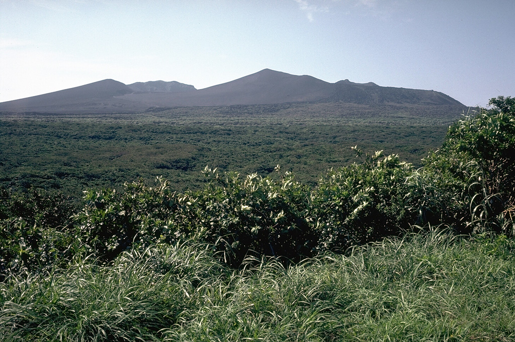 The Miharayama cone is located in the southern end of the 4-km-wide Oshima caldera, seen here inin the center of the view from the northern caldera rim. The high point of the eastern caldera rim, Shiraishidake, is the peak to the left. Photo by Tom Simkin, 1981 (Smithsonian Institution).