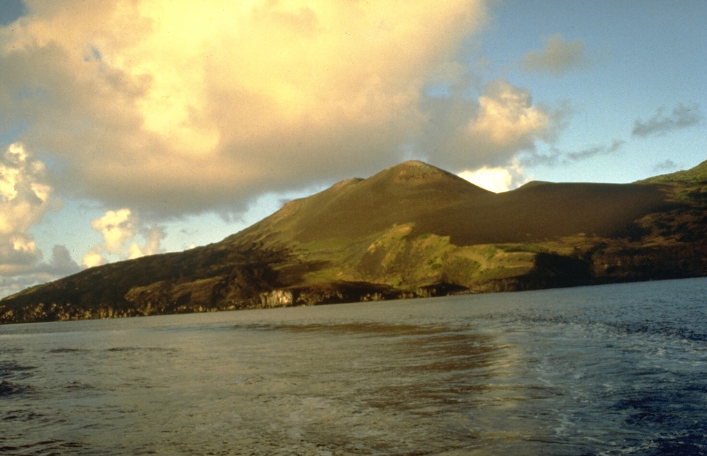 The northern volcano on the 2.8-km-wide island of Guguan is seen here from the west. An eruption between 1882 and 1884 formed the northern cone, which has three coalescing craters. Fresh lava flows that form the left coastline were produced during that eruption. Photo by Norm Banks, 1981 (U.S. Geological Survey).