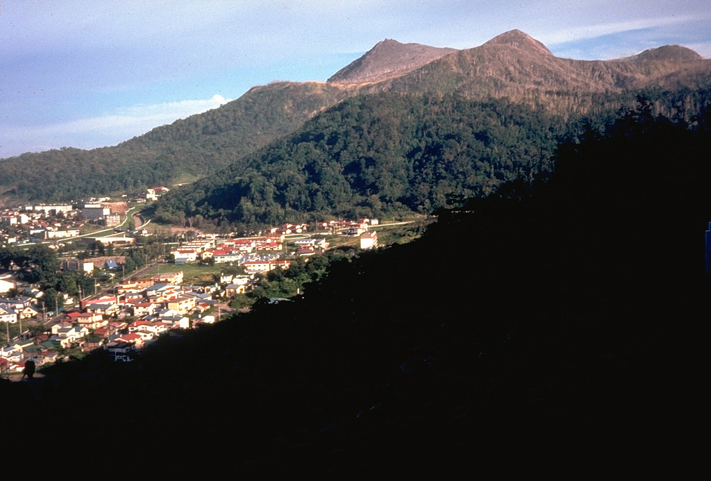 Usu volcano is a located on the southern topographic rim of the 110,000-year-old Toya caldera. The summit, seen here above the town of Toyako-Onsen to the NW, consists of dacitic lava domes and a cryptodome that were emplaced in a small summit caldera during historical eruptions. Photo by Dick Stoiber, 1981 (Dartmouth College).