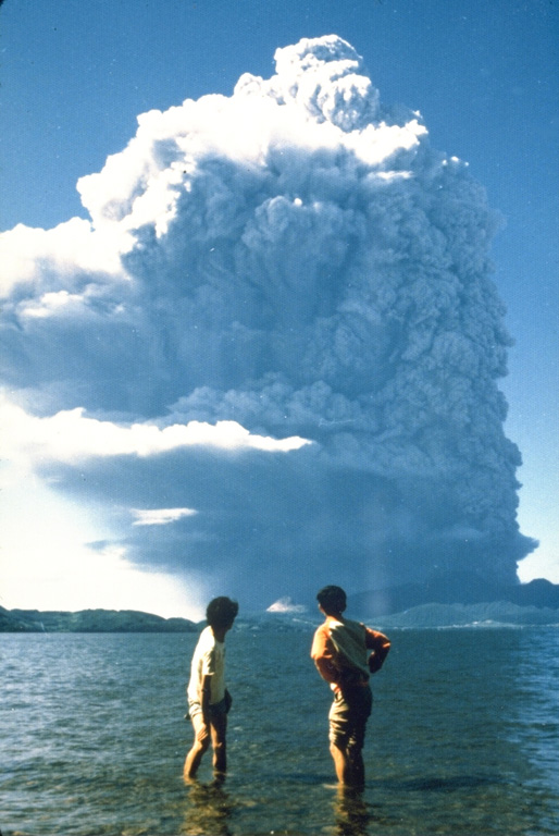 An ash plume from the first of nine major explosions of Usu during 7-14 August 1977 towers above Lake Toya. The plume rapidly grew to a height of 12 km. The explosive eruptions were followed by slow growth of a cryptodome (a lava dome that does not breach the surface) over a period of five years. Phreatic explosions accompanied cryptodome growth in November 1977 and January-October 1978. By the end of the 1982 eruption Usu-Shinzan had grown to 180 m above the crater floor. Photo by Asanuma, 1977.