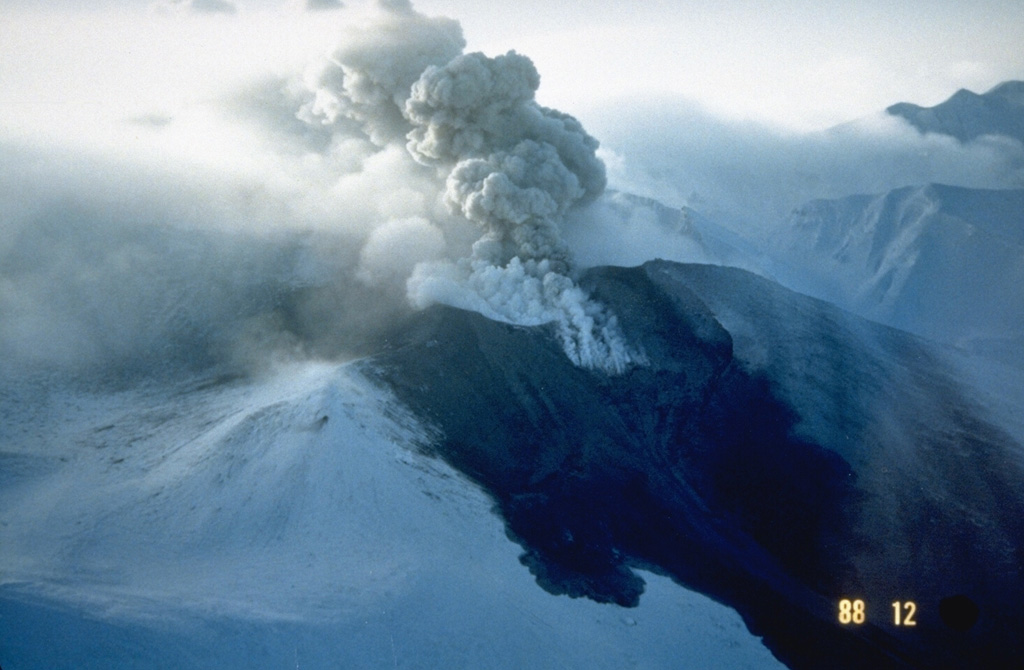 Snowpack on the western flank of Tokachi preserves individual layers of pyroclastic surge and pyroclastic flow deposits from the 1988-89 eruption. Because the eruptions took place during the winter, snowfall proved very useful to scientists in distinguishing the deposits of small-scale eruptions that lasted only a very short time. Photo courtesy of Japan Meteorological Agency, 1988.