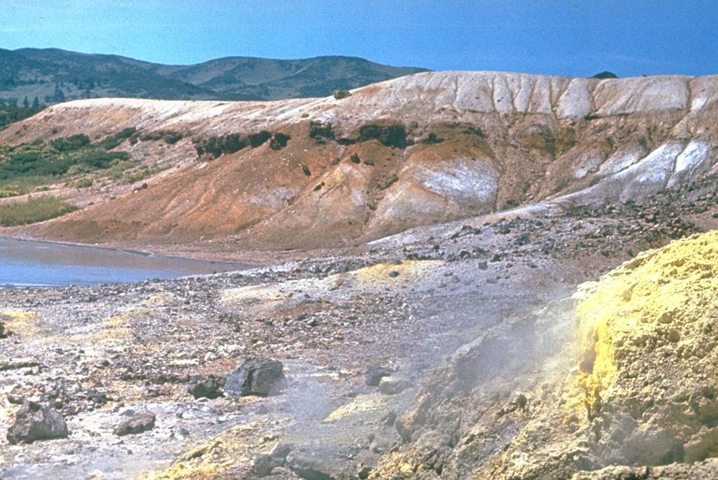 A crater in the 4 x 5 km Tomariyama caldera contains sulfur deposition in geothermal areas along the lake shore and beneath the lake. It is the southernmost volcano in the Kuril Islands and forms the southern end of Kunashir Island across the Nemuro Strait from Hokkaido. Several lava domes have formed within the caldera. Photo by Yuri Doubik (Institute of Volcanology, Petropavlovsk).