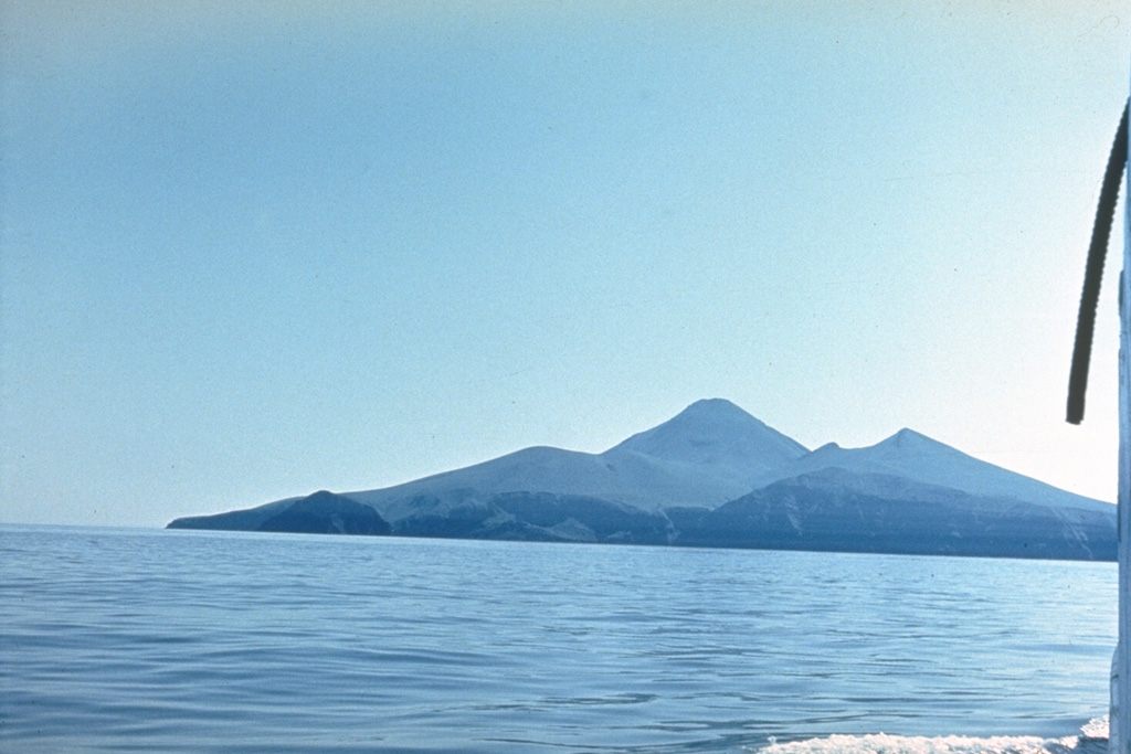 Chirpoi Island contains multiple volcanic edifices constructed within an 8-9 km wide, partially submerged caldera. This view from the east shows the Snow cone (left), Cherny (center), and the eroded Chirpoi to the right. Cherny erupted twice during the 18th and 19th centuries and Snow erupted between 1770 and 1810. It is composed almost entirely of lava flows, some of which form the shoreline in the foreground. Photo by Oleg Volynets (Institute of Volcanology, Petropavlovsk).
