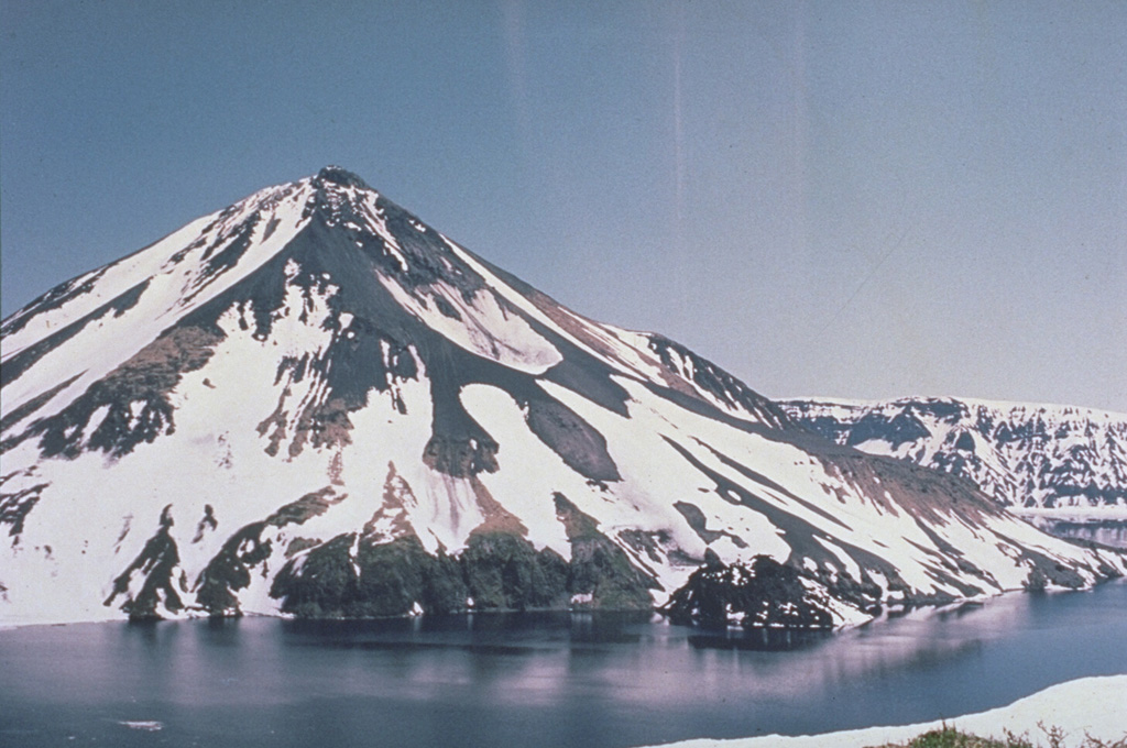 Krenitzyn Peak is a post-caldera cone that forms a 4-km island rising above the rim of 7.5-km-wide Tao-Rusyr caldera. It has a 350 m summit crater and a large shallow crater (left center) on the upper NE flank. The small dark mass along the eastern shoreline (right-center) is a lava dome that was emplaced in 1952. Kal'tsevoe lake fills a caldera that formed about 7,500 years ago during one of the largest Holocene eruptions in the Kuril Islands. Photo by Oleg Volynets (Institute of Volcanology, Petropavlovsk).