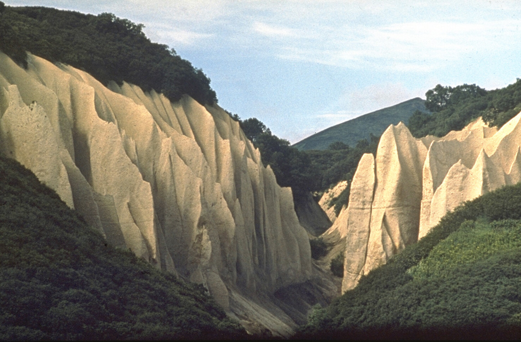 This renowned exposure of pyroclastic flow deposits from Kurile Lake caldera has been named Kutkhiny Baty because of its erosional features. The pyroclastic flow deposit originated from the caldera-forming eruption of Kurile Lake about 7,600 years ago, one of the largest Holocene eruptions in Kamchatka. The deposit is about 100 m thick at this location on the Ozernaya River, 3 km W of Kurile Lake. Photo by Oleg Volynets (Institute of Volcanology, Petropavlovsk).