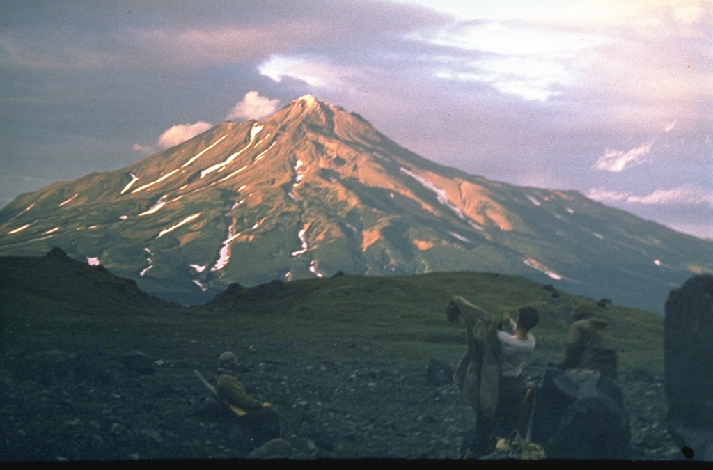 Zheltovsky, seen here from Diky Greben volcano to its SW, was constructed during the last 8,000 years within a 4 x 5 km caldera truncating an earlier Pleistocene edifice. A late-Holocene explosive eruption formed a 1.6-km-wide summit crater that was largely filled by four lava domes, the latest of which forms the present summit. A large eruption in 1923 produced explosive activity and a lava flow down the SE flank that partially flowed into a crater. Photo by Oleg Volynets (Institute of Volcanology, Petropavlovsk).