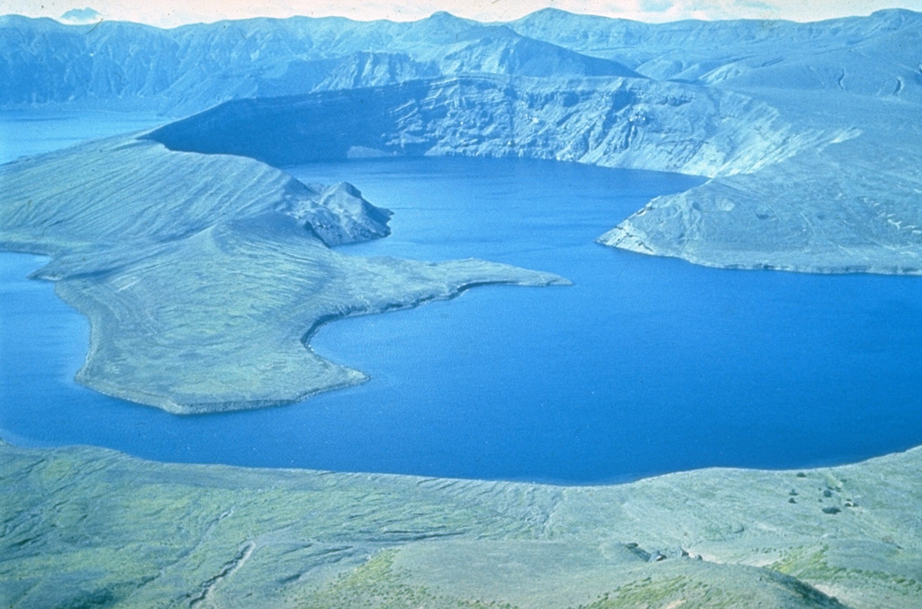 One of the largest 20th-century eruptions in Kamchatka took place in March 1907 from Shtyubel' Crater (center) within the Ksudach caldera. Plinian explosive eruptions deposited 1.5 km3 of ash that extended as far as 1,000 km to the NNE. Plinian activity was followed by a laterally-directed explosion and the destruction of the Shtyubel' cone. Pyroclastic flows and surges traveled to the NW and over the Ksudach caldera walls. The eruption formed a chain of three craters (seen here from the NE) and lowered the height of the cone by about 650 m. Photo by Yuri Doubik (Institute of Volcanology, Petropavlovsk).