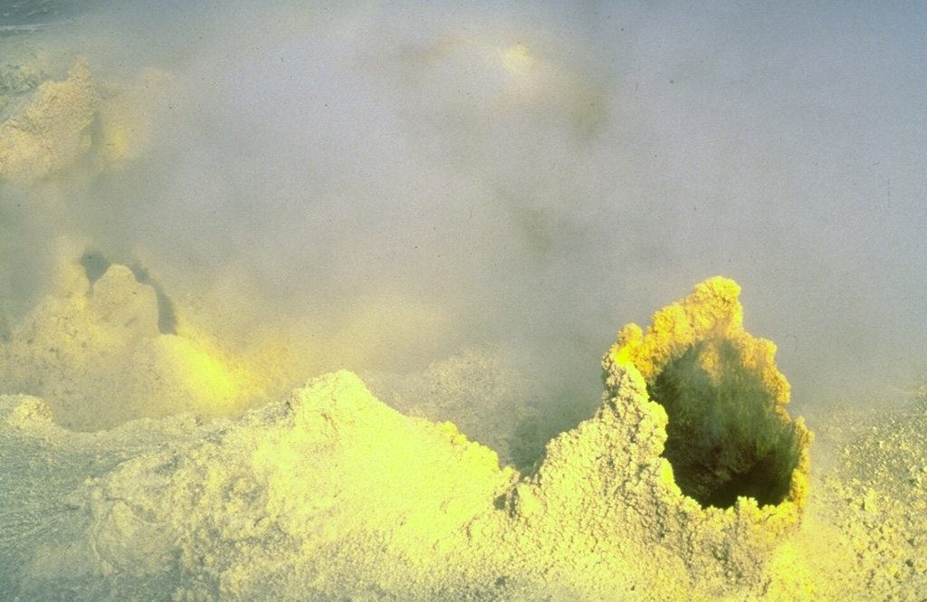 Gases rise from a sulfur-encrusted, ~2 m high fumarolic vent on Mutnovsky. Widespread fumarolic activity occurs in several craters. The Verkhneye fumarole field covers a 3,200 m2 area of the NW part of the active crater. The Donnoye fumarole field on northern Mutnovsky occupies a former crater lake. Photo by Phil Austin, University of Southern Florida, 1992 (courtesy of Pavel Kepezhinskas).