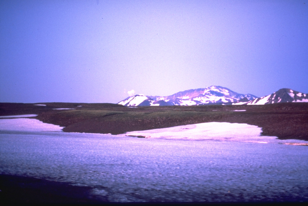 Gorely consists of five small overlapping edifices constructed within a large Pleistocene caldera that formed about 40,000-50,000 years ago. The rims of the 9 x 13.5 km caldera form the flat area on the center horizon and the peak at the right, seen here from the south. The Gorely complex contains 11 summit and 30 flank craters. Historical eruptions have largely consisted of moderate Vulcanian and phreatic explosions. Photo by Phil Austin, University of Southern Florida, 1992 (courtesy of Pavel Kepezhinskas).