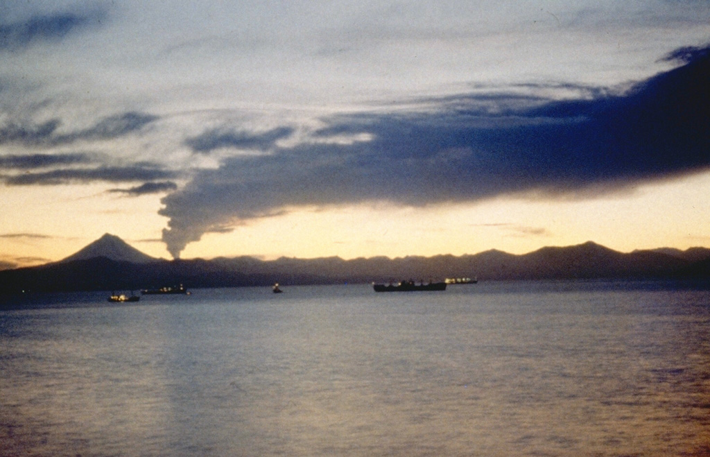 An ash plume from Gorely drifts to the N across Avachinsky Bay in this 1980 view from Petropavlovsk, Kamchatka's largest city. Explosive activity began in June 1980 and intermittent explosions took place until July 1981. An explosion on 31 July produced a plume that rose up to 5.5-km altitude, and a pyroclastic flow was produced on 3 December 1980.  Photo by Kamchatka Volcanic Eruptions Response Team, 1980 (courtesy of Dan Miller, U.S. Geological Survey).