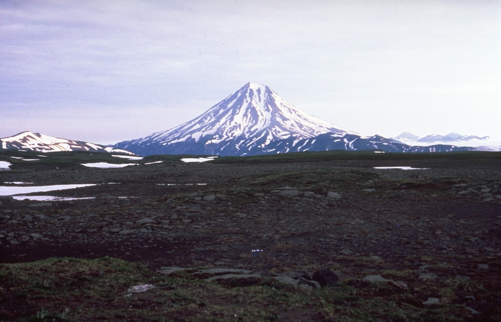 Vilyuchik is a Holocene volcano that forms a prominent landmark south of Avachinsky Bay. It is seen here from the south between Mutnovsky and Gorely volcanoes. Deep erosional valleys are visible on the flanks, and lava domes scoria cones were constructed at its base.  Photo by Phil Austin, University of Southern Florida, 1992 (courtesy of Pavel Kepezhinskas).
