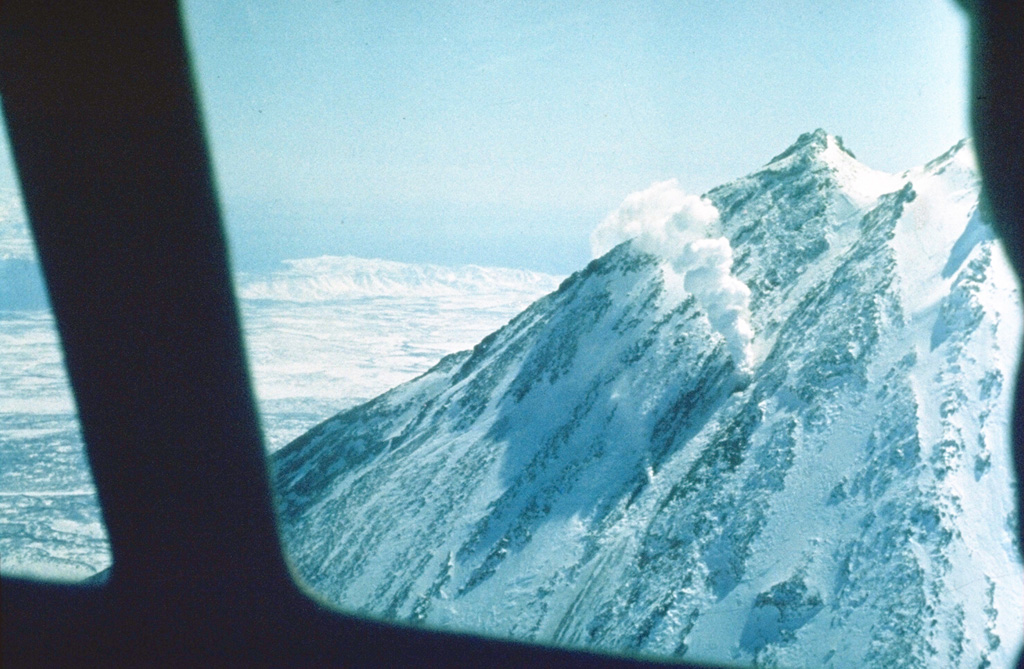 An aerial view of the Koryaksky summit shows a NW-flank fumarole that has remained active since a 1956-57 eruption. Explosive activity took place from the summit crater (forming the notch to the upper-right) and a radial fissure that extended from 3,100 to 3,000 m elevation on the upper NW flank. The eruption began in December 1956 and reached its peak in late January, when the strongest explosions occurred. Photo by Oleg Volynets (Institute of Volcanology, Petropavlovsk).