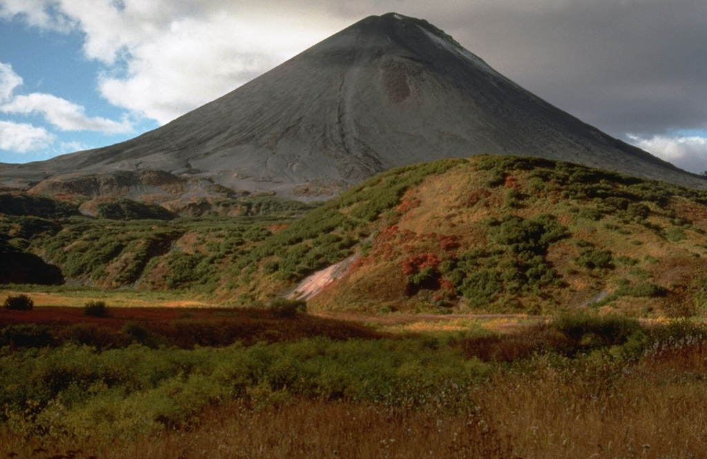 Symmetrical Karymsky volcano fills much of a 5-km-wide, early Holocene caldera. Its flanks, seen here from the south, are largely mantled by lava flows and pyroclastic deposits less than 200 years old. Photo by Dan Miller, 1990 (U.S. Geological Survey).
