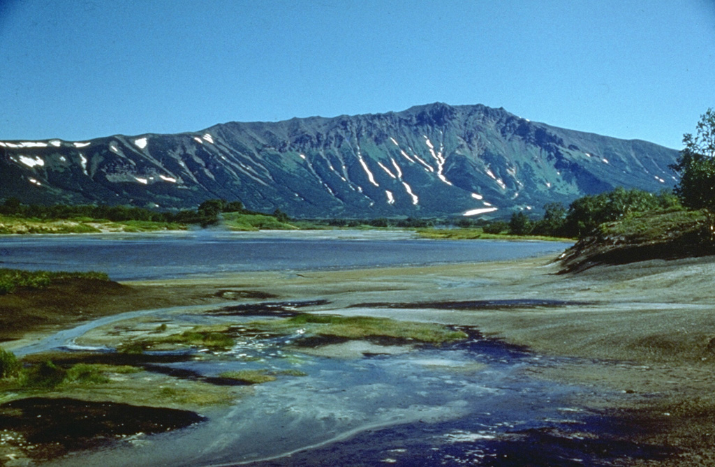 The Vostochny Thermal Field in the northern part of Uzon caldera contains a large number of thermal lakes and springs. A narrow area 200-300 m x 5 km contains fumaroles, boiling hot springs with colonies of blue-green algae, and mud pots. The northern caldera wall forms the ridge in the background. Photo by V.N. Nechaev (courtesy of Oleg Volynets, Institute of Volcanology, Petropavlovsk).
