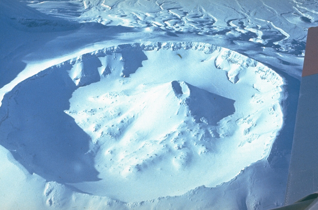 The 800-m-wide crater of the northern cone of Krasheninnikov is seen here looking west across the crater. An eruption 400 years ago formed the small Pauk cone within this crater, and also produced a lava flow from a vent on the upper SW flank of the southern cone (at left out of view). Photo by Yuri Doubik (Institute of Volcanology, Petropavlovsk).