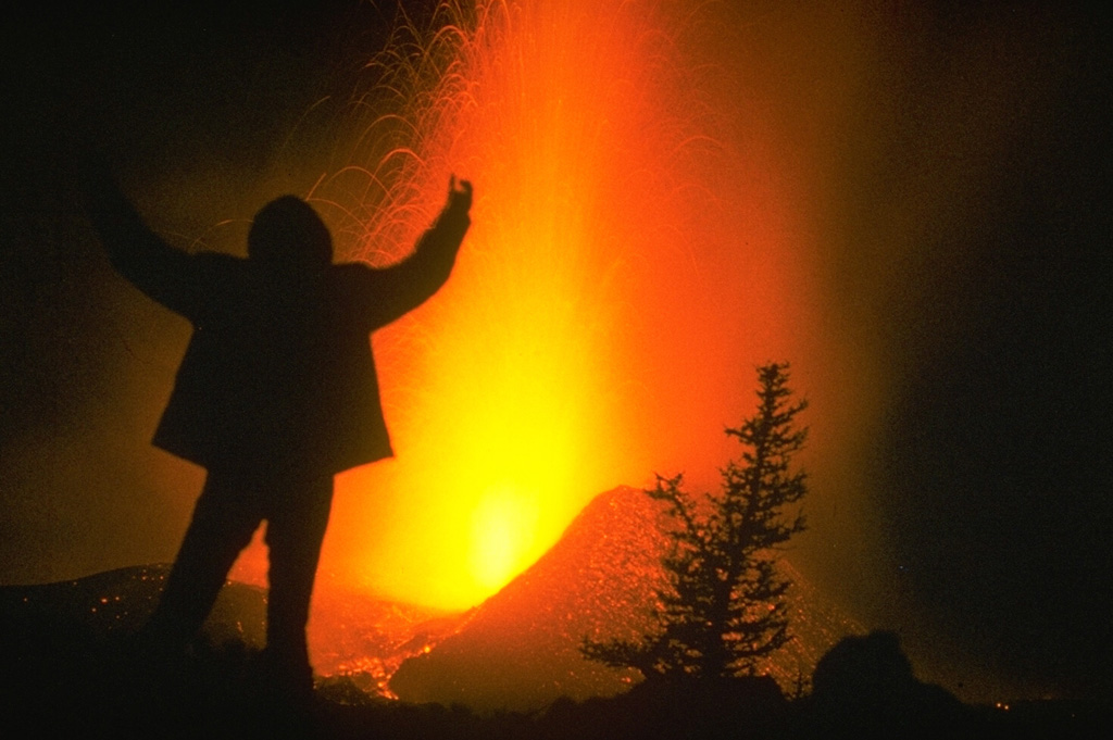 A volcanologist from the Institute of Volcanology in Petropavlovsk stands in front the 1975-76 Tolbachik eruption. Incandescent blocks can be seen in this nighttime photograph. This was Kamchatka's largest basaltic eruption during the past 10,000 years. Photo by Oleg Volynets, 1975 (Institute of Volcanology, Petropavlovsk).