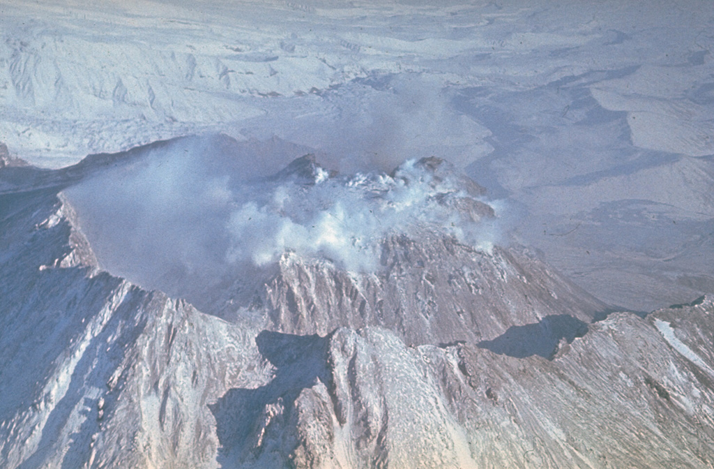 The Novy lava dome at Kamchatka's Bezymianny volcano began growing in 1956 within the large horseshoe-shaped crater. The 1.8 x 2.5 km crater formed during the catastrophic 1956 eruption flank collapse that resulted in a debris avalanche and lateral blast to the E. This 1980's view from the SW shows the dome within the crater, which subsequently grew to the height of the crater rim. Photo by Yuri Doubik (Institute of Volcanology, Petropavlovsk).